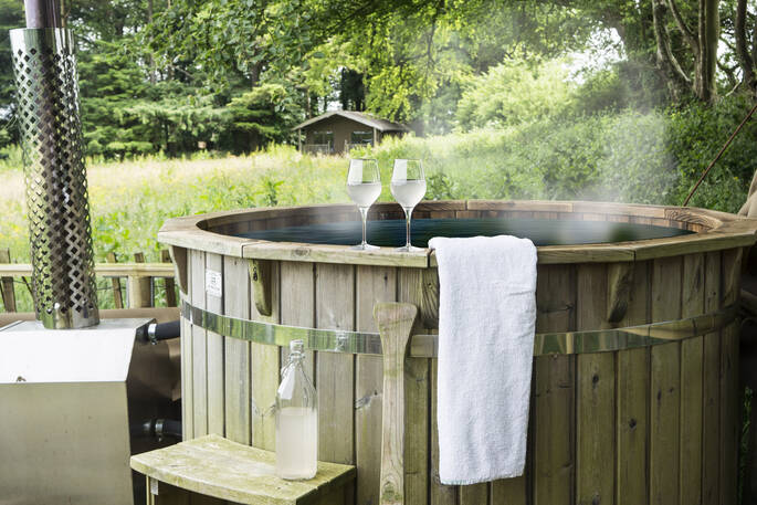 Relax and soak in the wood fired hot tub at Berridon Farm, after a long day of exploring