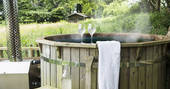Relax and soak in the wood fired hot tub at Berridon Farm, after a long day of exploring