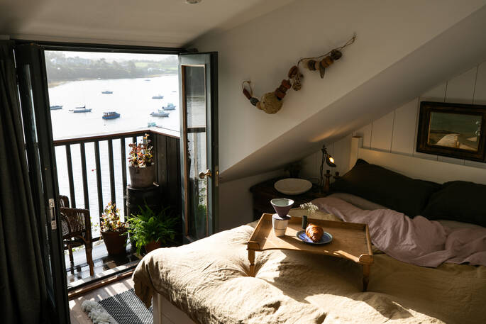 Throw open the balcony doors and lie in bed enjoying the view at Bowcombe Boathouse in Devon 