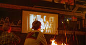 Set up your favourite movie on the projector and watch it sitting by the firepit