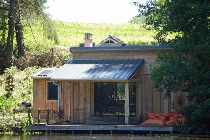Exterior of GoGreen cabin with outdoor BBQ and large decking at GoGreen holidays in Dordogne, France 
