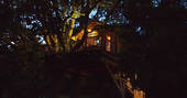 La Cabane du Perche treehouse lit up at night