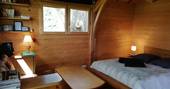 Inside La Cabane du Perche treehouse, with comfortable double bed